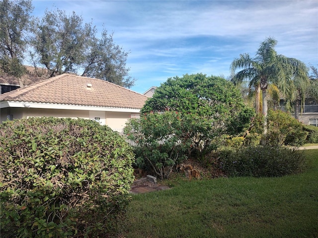 view of property exterior with a lawn