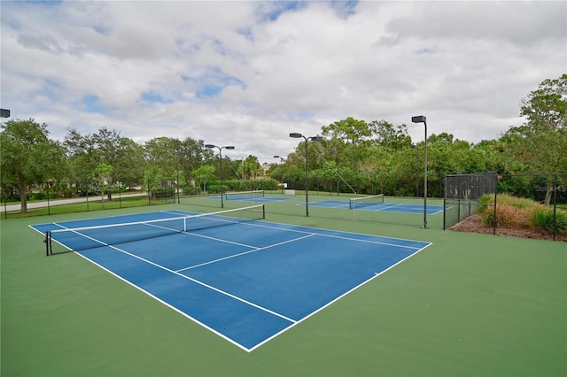 view of tennis court featuring basketball hoop