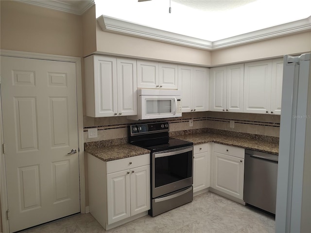 kitchen featuring white cabinetry, stainless steel appliances, backsplash, light tile patterned floors, and ornamental molding