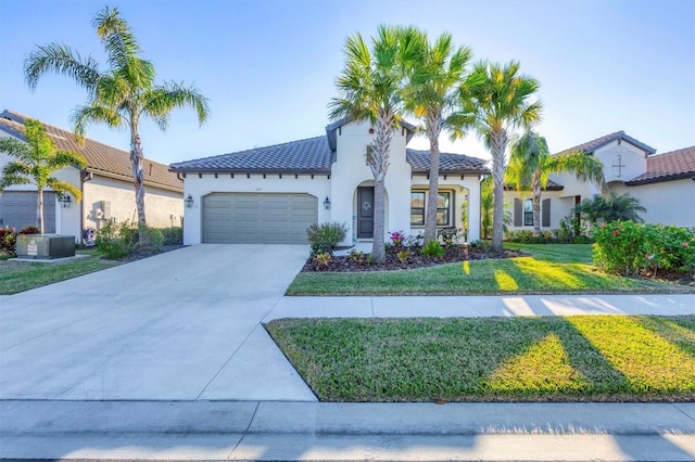 mediterranean / spanish-style house featuring cooling unit, a front yard, and a garage