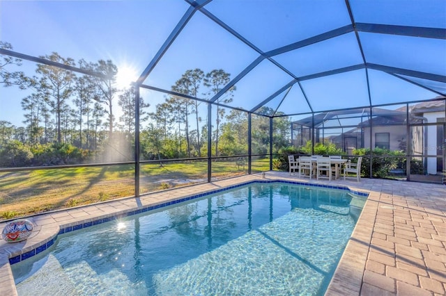 view of pool with a patio and glass enclosure