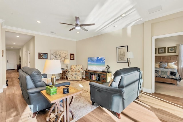 living room with light hardwood / wood-style flooring, ceiling fan, and crown molding