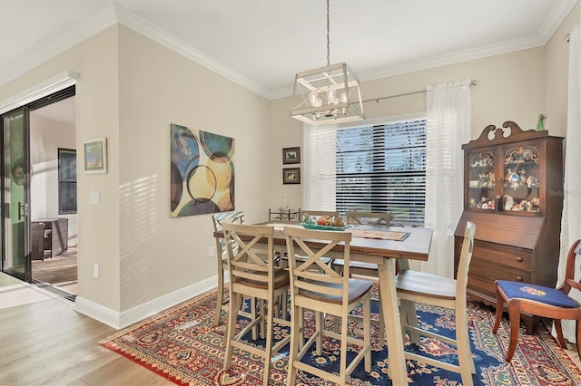 dining room featuring hardwood / wood-style flooring and ornamental molding