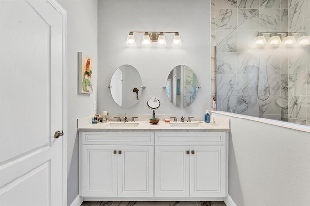 bathroom with a tile shower and vanity