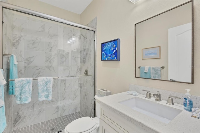 bathroom featuring vanity, an enclosed shower, and toilet