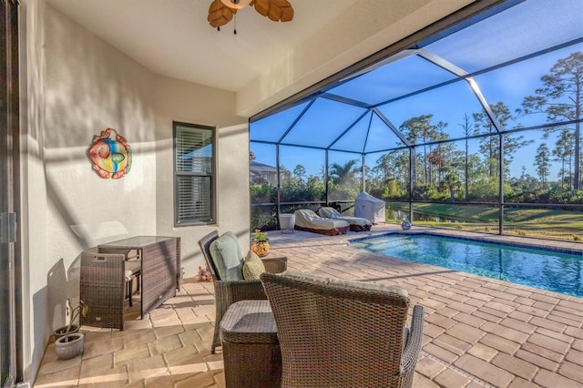 view of pool with a lanai, ceiling fan, and a patio area