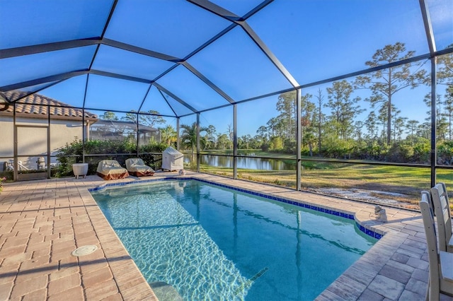 view of pool with a patio, a water view, and a lanai