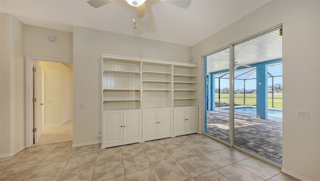 interior space with light tile patterned floors and ceiling fan