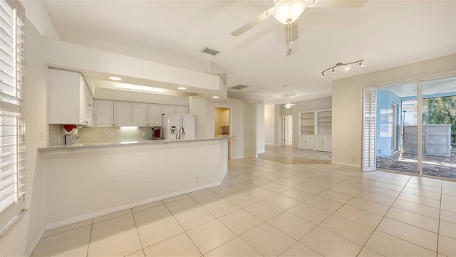 kitchen featuring ceiling fan, light tile patterned floors, white cabinets, and white appliances