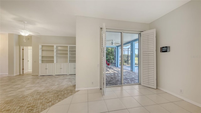 empty room featuring ceiling fan and light tile patterned flooring