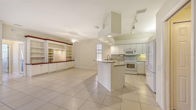 kitchen with light tile patterned flooring, white cabinetry, ceiling fan, white appliances, and decorative backsplash