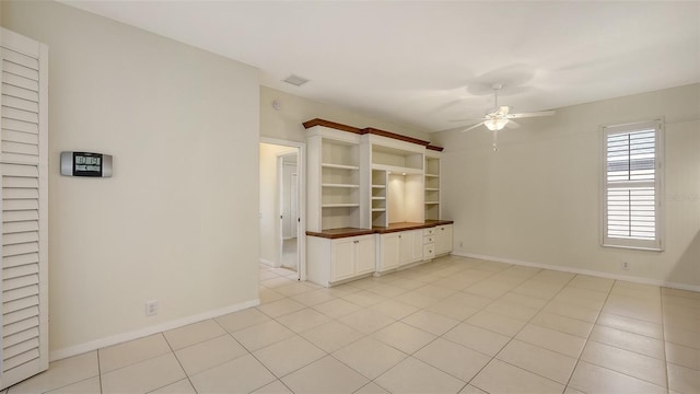 unfurnished living room with light tile patterned floors and ceiling fan