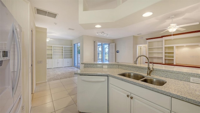 kitchen with refrigerator with ice dispenser, sink, dishwasher, white cabinetry, and light tile patterned flooring