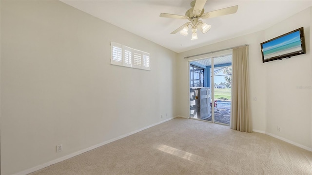 carpeted empty room featuring ceiling fan