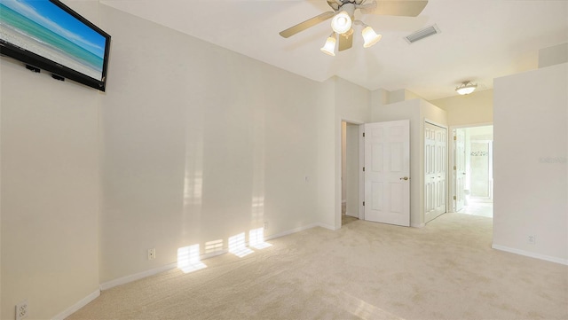 spare room with light carpet and ceiling fan