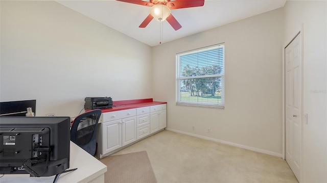 home office featuring ceiling fan and light carpet