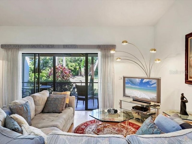 living room featuring tile patterned floors and a healthy amount of sunlight