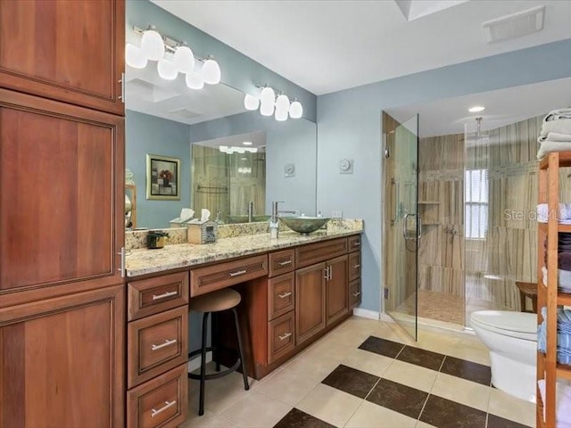 bathroom featuring tile patterned floors, vanity, toilet, and walk in shower