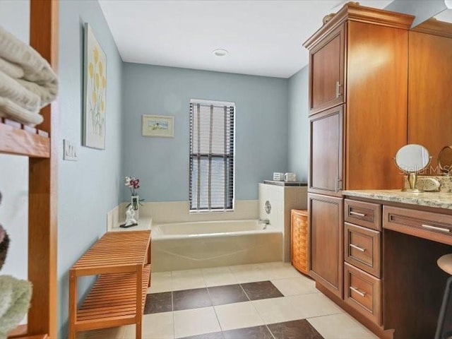 bathroom with vanity, a tub to relax in, and tile patterned floors