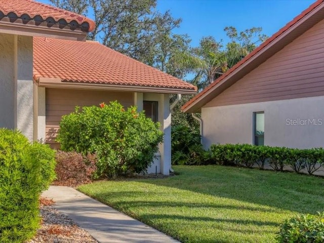 view of property exterior with a lawn