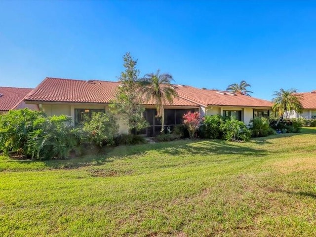 rear view of house featuring a lawn