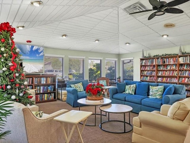 living room featuring carpet and ceiling fan