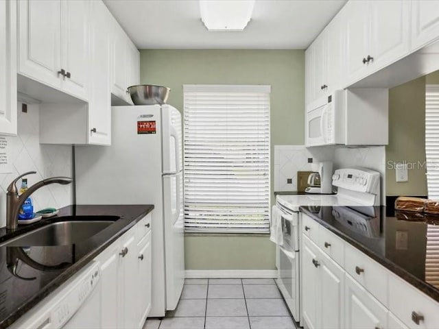 kitchen with tasteful backsplash, white appliances, sink, white cabinetry, and light tile patterned flooring