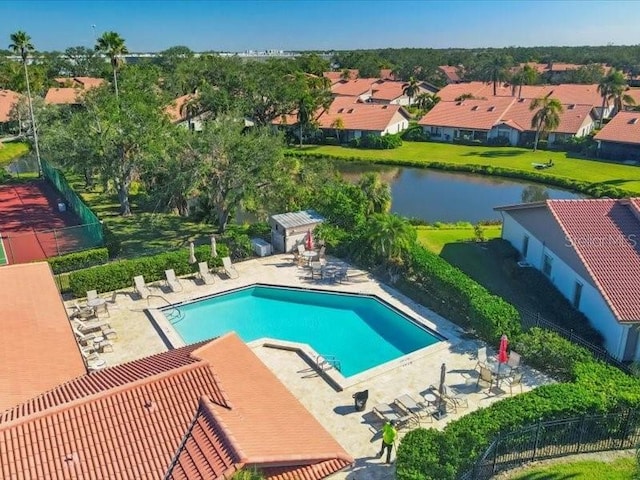 view of pool with a patio area and a water view