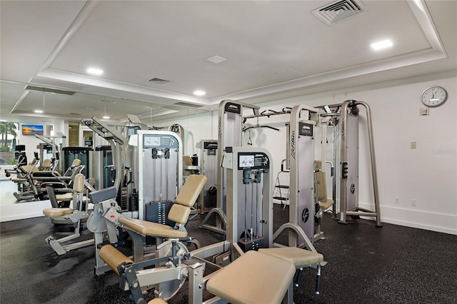 workout area featuring a tray ceiling