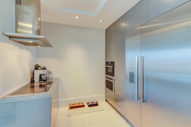 kitchen with electric cooktop, built in fridge, and island range hood