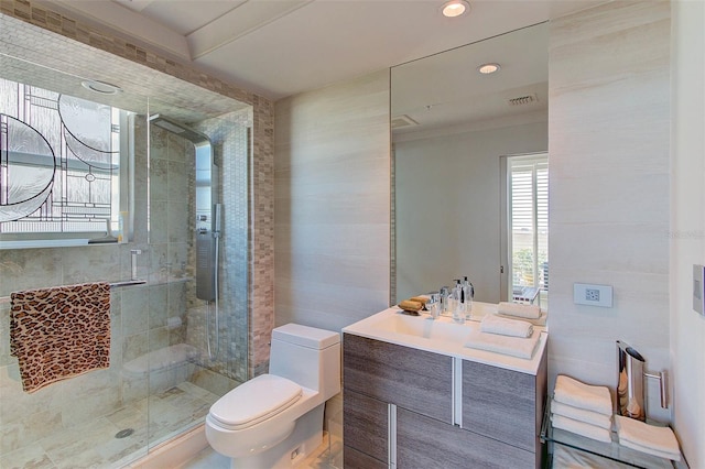 bathroom featuring vanity, toilet, walk in shower, and tile walls