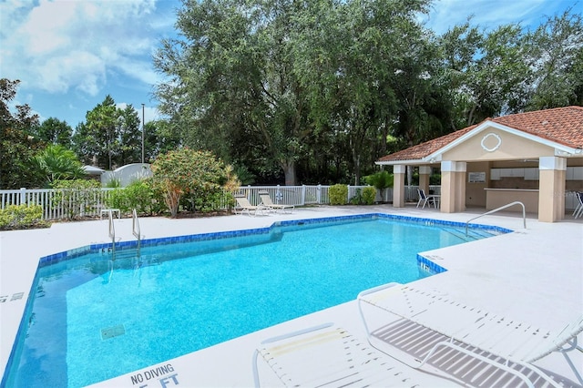 view of swimming pool with a patio area