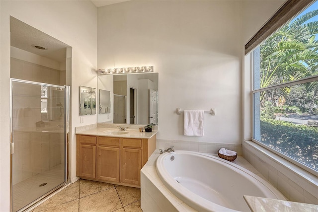 bathroom featuring vanity, separate shower and tub, tile patterned floors, and plenty of natural light