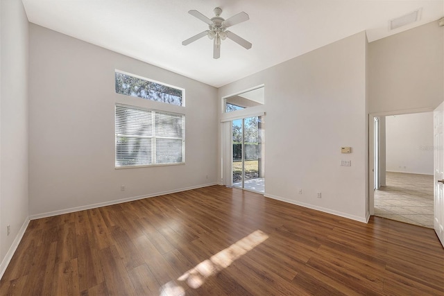 spare room featuring ceiling fan and dark hardwood / wood-style floors