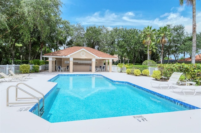 view of swimming pool featuring an outdoor structure and a patio area