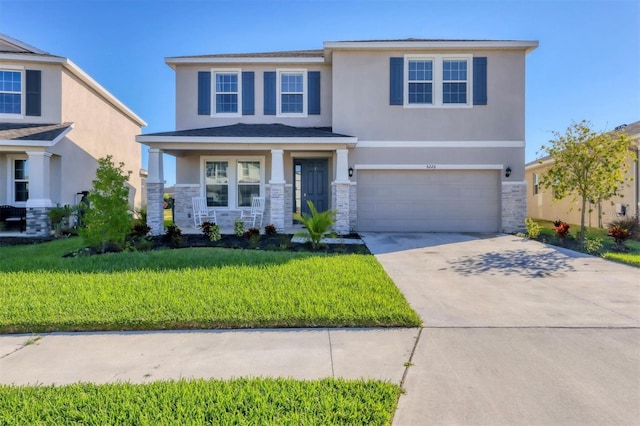 view of front facade with a garage and a front lawn