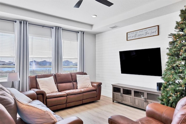 living room featuring ceiling fan and light hardwood / wood-style flooring