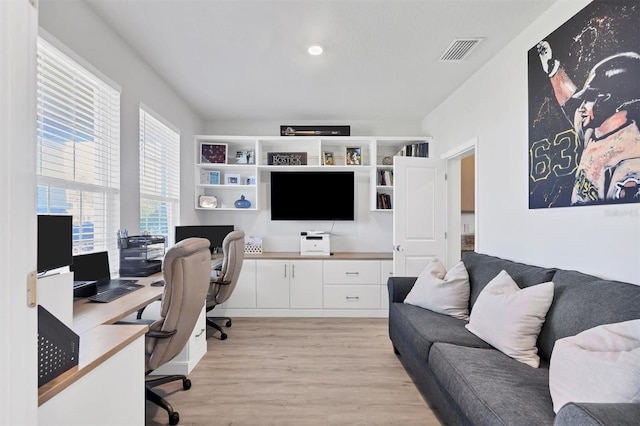 office area with plenty of natural light and light hardwood / wood-style flooring