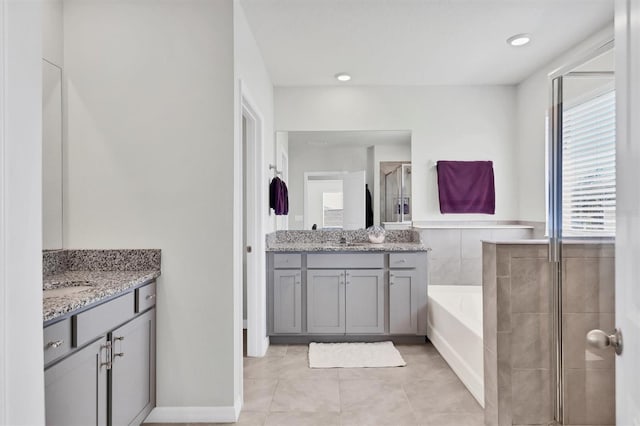 bathroom featuring tile patterned floors, vanity, and shower with separate bathtub