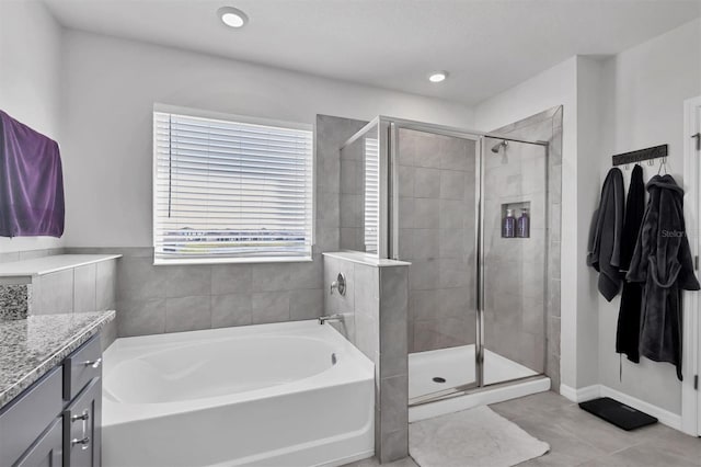 bathroom featuring tile patterned floors, vanity, and independent shower and bath