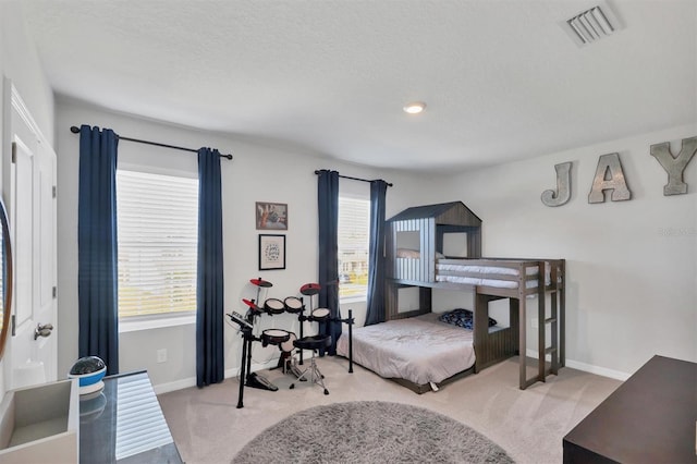 carpeted bedroom with multiple windows