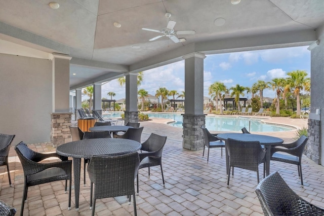 view of patio / terrace featuring ceiling fan and a community pool