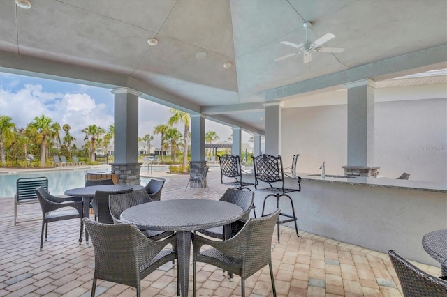 view of patio with ceiling fan and exterior bar