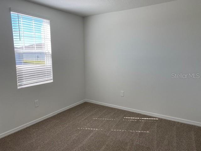 empty room with dark carpet