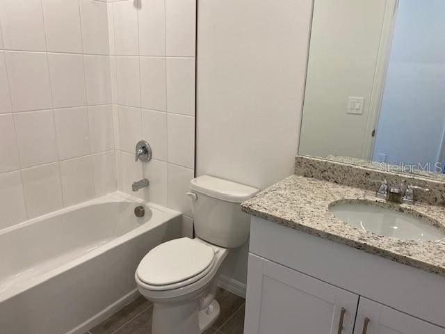 full bathroom featuring vanity, toilet, and tiled shower / bath