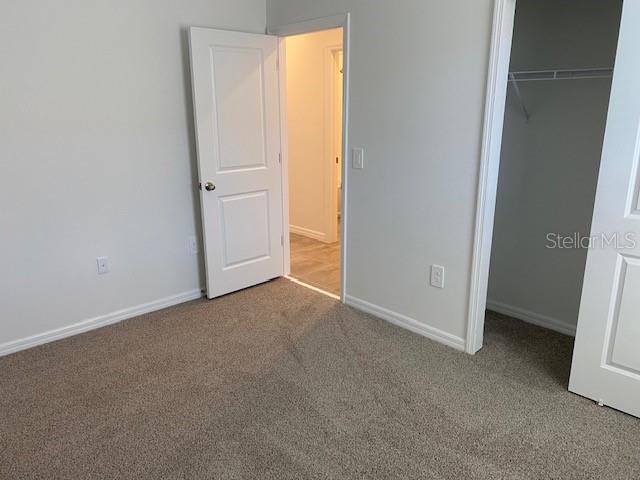 unfurnished bedroom with carpet floors and a closet