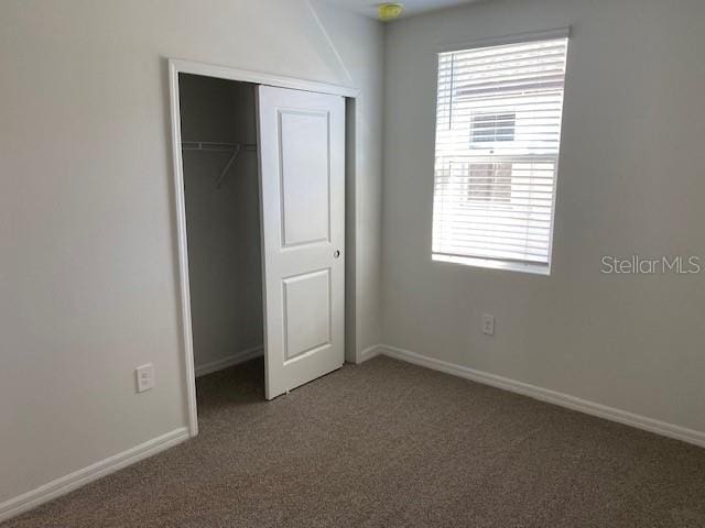 unfurnished bedroom with carpet floors and a closet