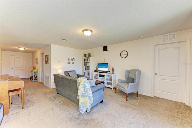 living room with light colored carpet and a textured ceiling