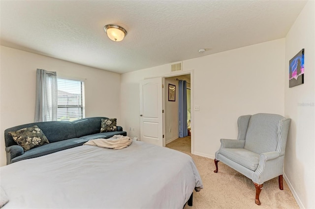 carpeted bedroom with a textured ceiling