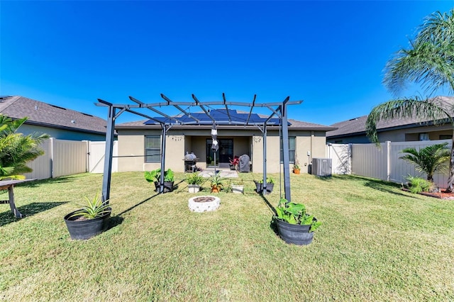 view of yard with central AC unit, an outdoor fire pit, and a patio area